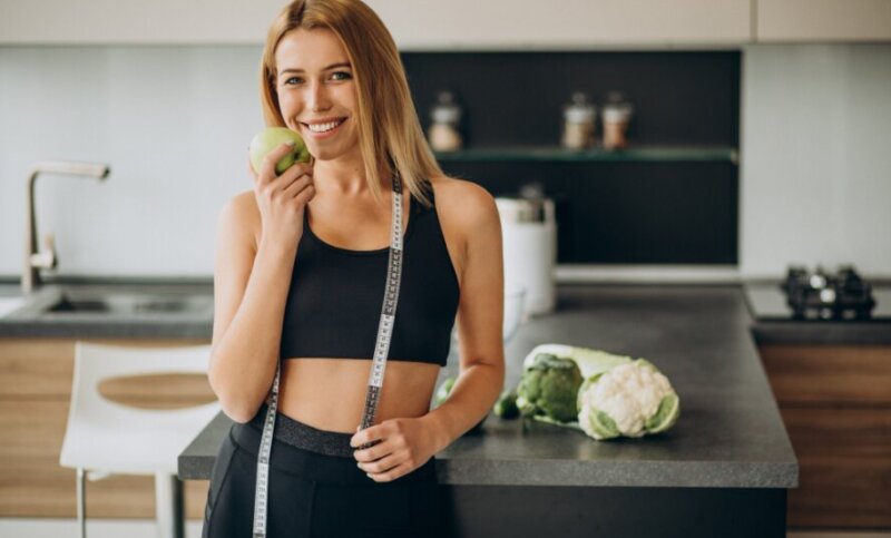 young-woman-with-measuting-tape-kitchen